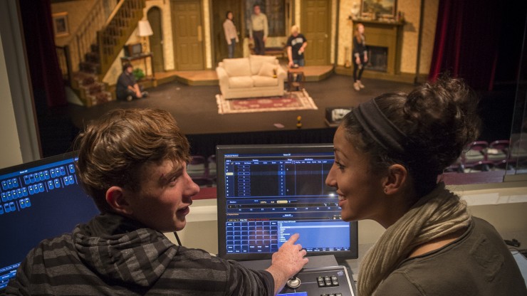 Two students running the light board for a theatre rehearsal in the Main Stage.