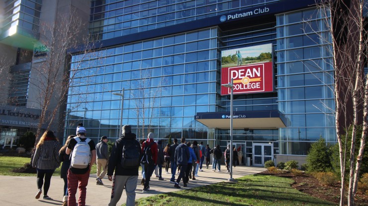 A group of students walking into the Putnam Club in Gillette Stadium to receive a tour of the facility. 