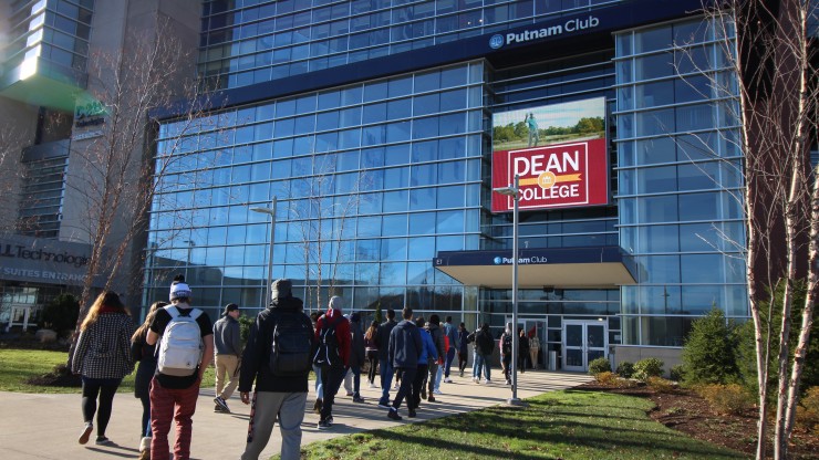 A group of students walking into the Putnam Club in Gillette Stadium to receive a tour of the facility.