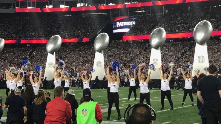 Dean College students performing on the field at Gillette Stadium.