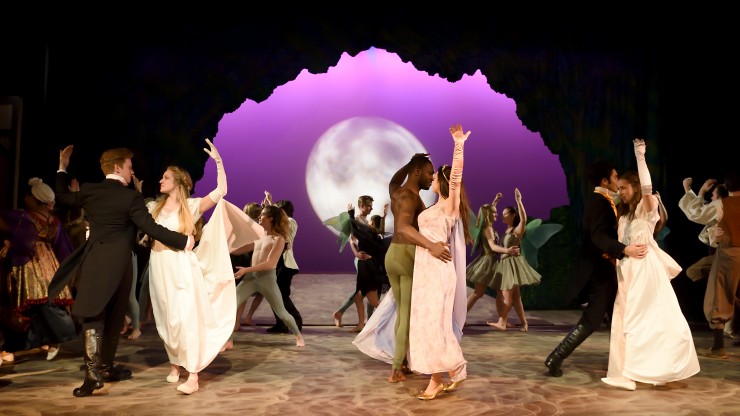 Students dancing while in costume during A Midsummer Night's Dream performance.