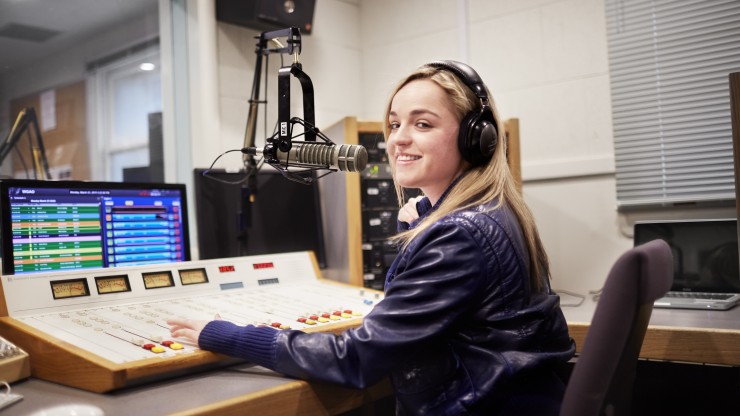 A student broadcasting live in the Power88 radio station.