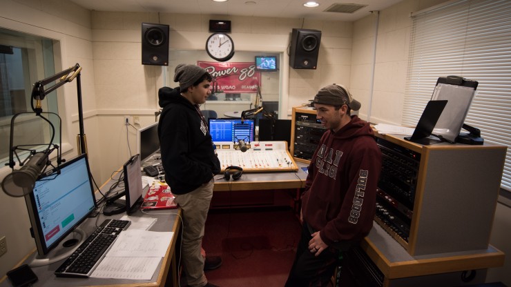 Two students working at the Power88 radio station.