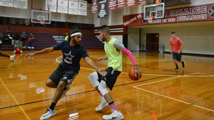 Students playing basketball in the Pieri Gymnasium.