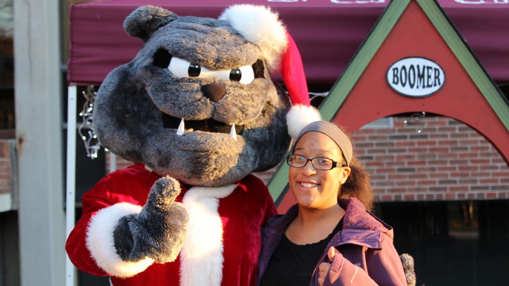 Boomer and student smiling at the camera during the Annual Tree Lighting ceremony.
