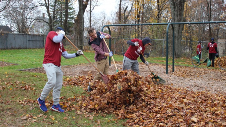 Students raking leaves at Nason Street park.