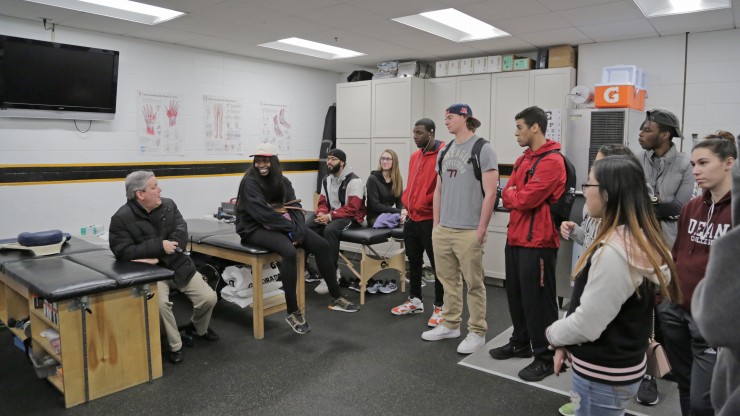 A professor speaks to a group of students while on a tour of the Dunkin Donuts Center, home of the Providence Bruins. 